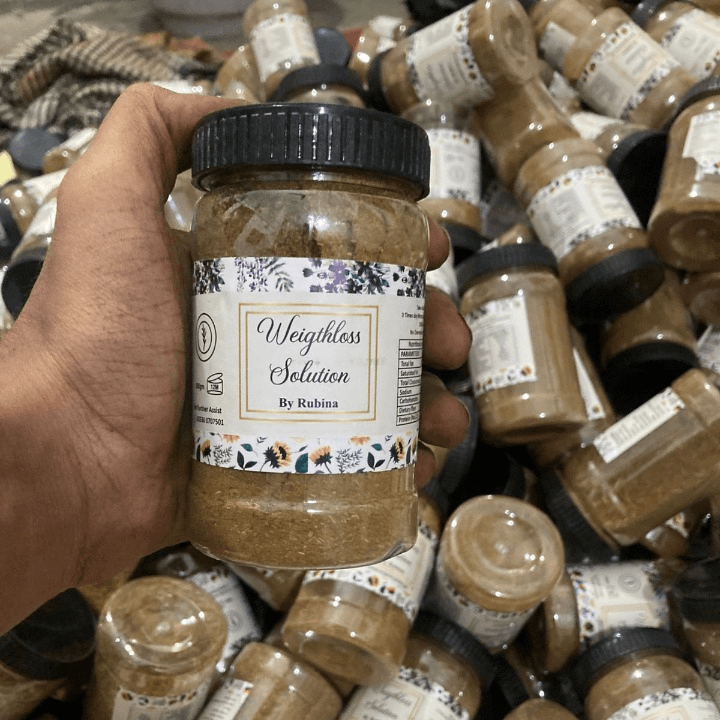 Hand holding a jar labeled 'Weightless Solution by Rubina' amidst other similar jars - Zarurat Hub